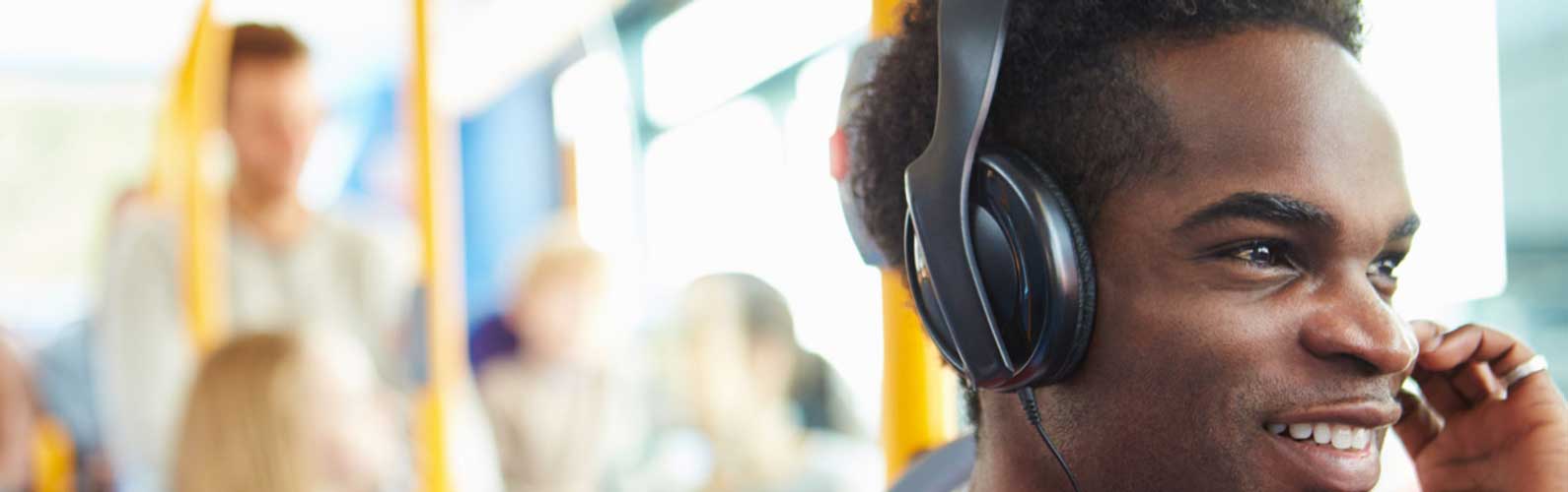 Man listens to News while riding an EC Rider Bus.